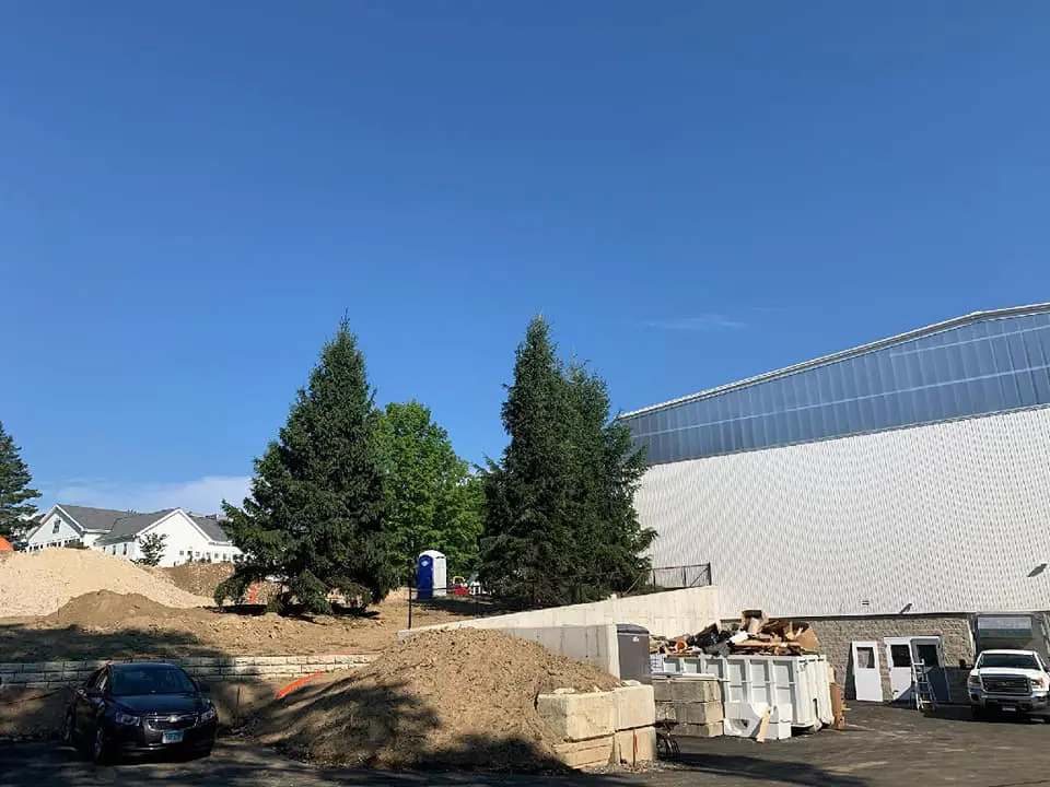 Construction site with trees and clear sky.